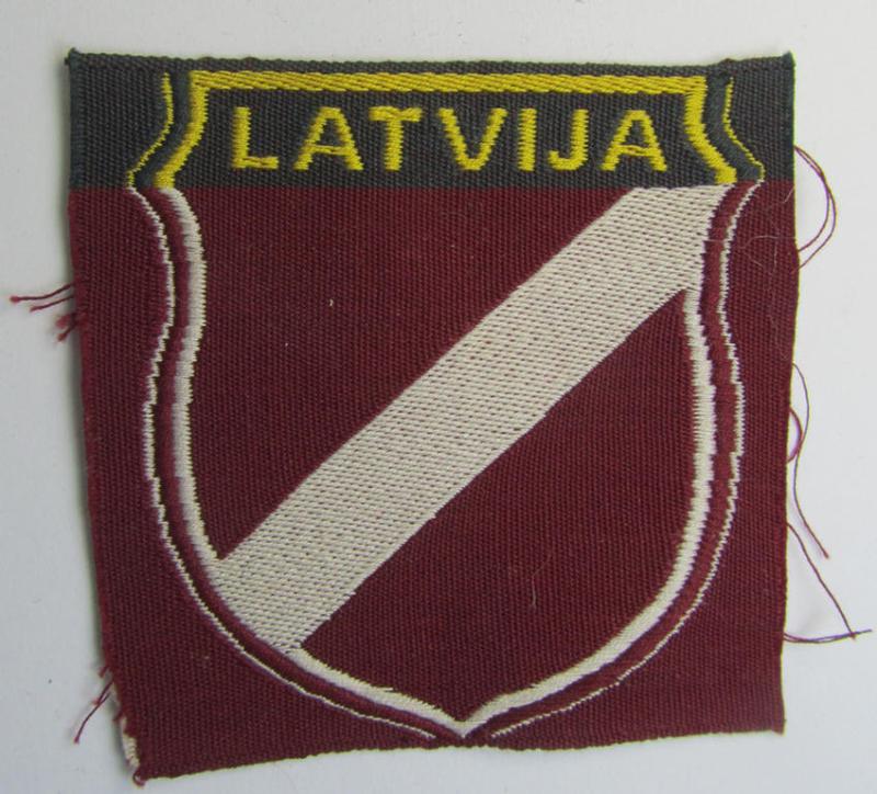 Superb - and truly rarely seen! - locally produced(!), 'Waffen-SS'-type armshield as executed in the so-called: 'semi-BeVo'-pattern entitled: 'Latvia' as was merely intended for usage by the members of the: 'Latvian Legion'