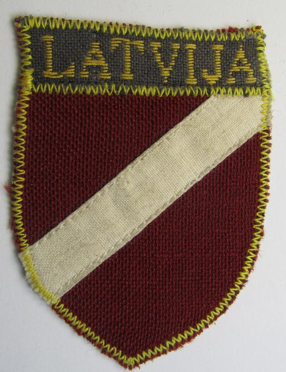 Superb - and truly rarely seen! - locally produced(!), 'Waffen-SS'-type armshield as (partly) executed in the so-called: 'semi-BeVo'-pattern entitled: 'Latvia' as was merely intended for usage by the members of the: 'Latvian Legion'