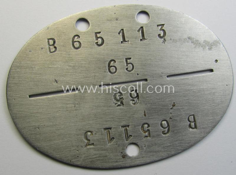Aluminium-based, WH (Luftwaffe-) ie. 'Flieger'-related ID-disc, bearing the clearly stamped- and/or: 'coded'-unit- ie. 'MOB'-designation that reads: 'B65113' (and as such belonging to a soldier who served within the: '9./Kampfgeschwader 51')
