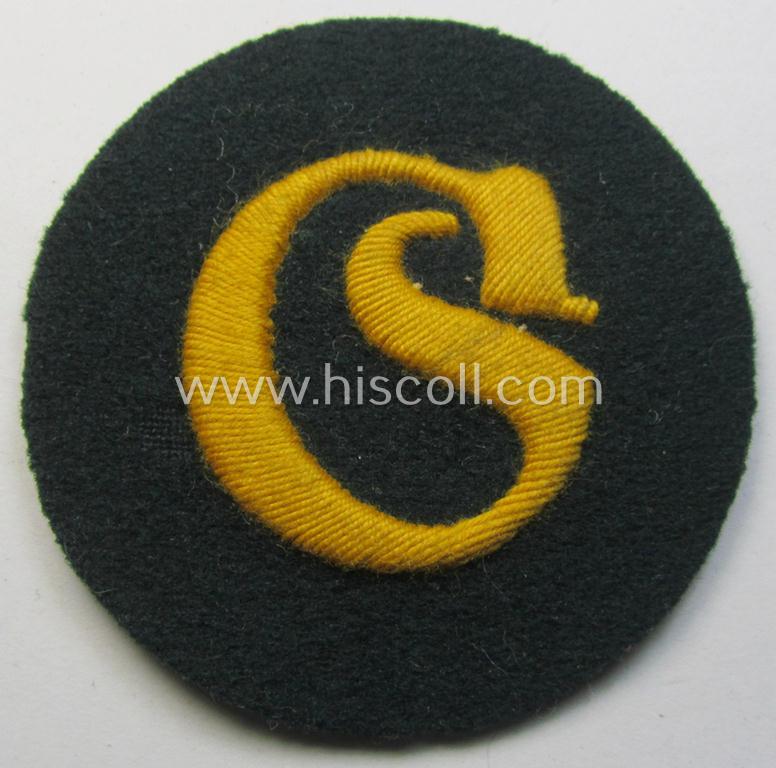WH (Heeres) so-called: trade- and/or special-career arm-insignia (ie. 'Laufbahn- o. Tätigkeitsabzeichen') as intended for a: 'Schirrmeister' (being a neatly hand-embroidered variant as mounted onto a darker-green woolen background)