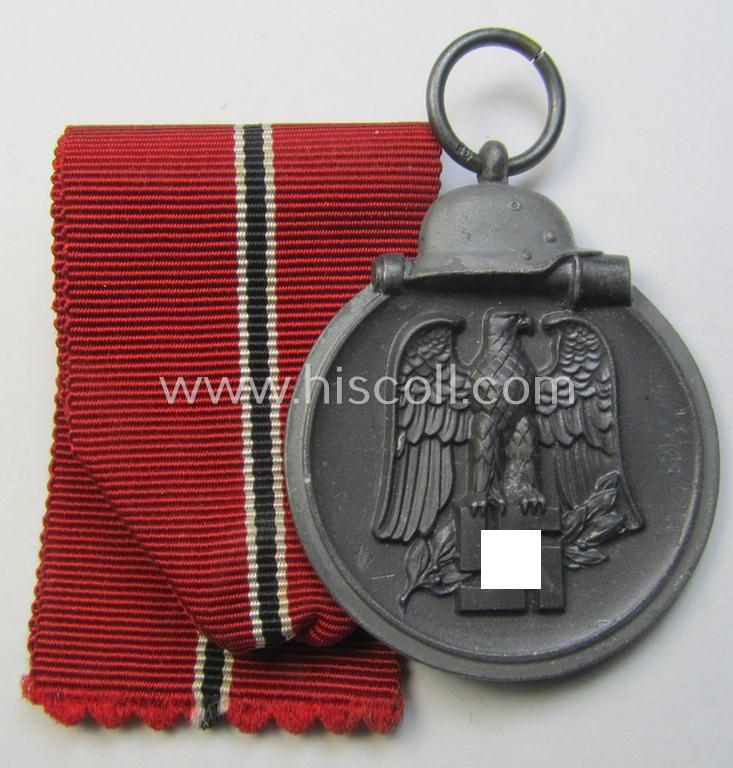 Attractive medal-set: 'Winterschlacht im Osten 1941-42' being a maker- (ie. '6.'-) marked- (and/or 'Feinzink'-based) specimen by the maker: 'Fritz Zimmermann' and that comes together with its (minimally confectioned) ribbon (ie. 'Bandabschnitt')