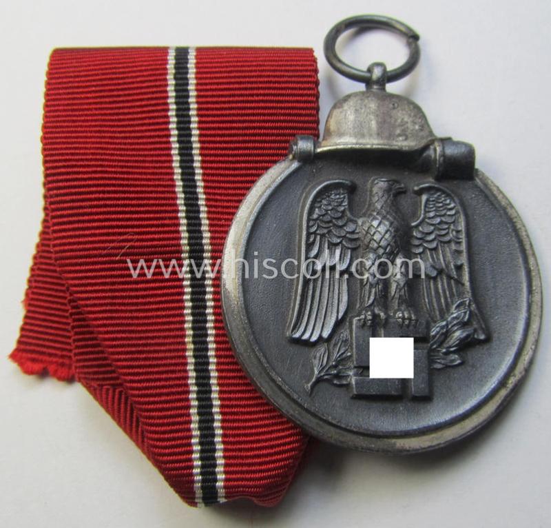 Attractive medal-set: 'Winterschlacht im Osten 1941-42' being a maker- (ie. '14'-) marked- (and/or 'Feinzink'-based) specimen by the maker: 'L.Chr. Lauer' and that comes together with its (minimally confectioned) ribbon (ie. 'Bandabschnitt')