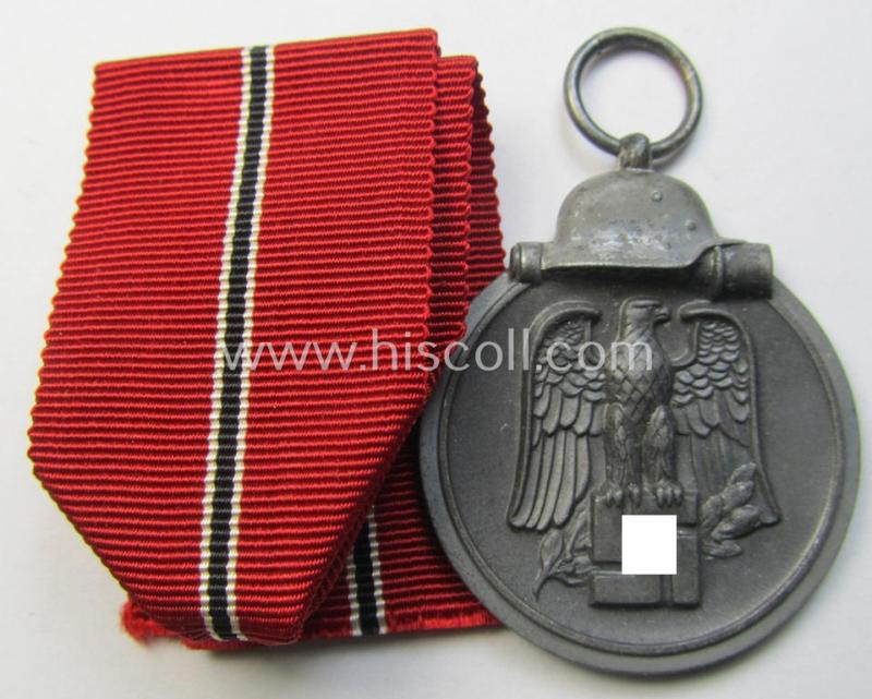 Attractive medal-set: 'Winterschlacht im Osten 1941-42' being a maker- (ie. '60'-) marked- (and/or 'Feinzink'-based) specimen by the maker: 'Katz & Deyhle' and that comes together with its (minimally confectioned) ribbon (ie. 'Bandabschnitt')