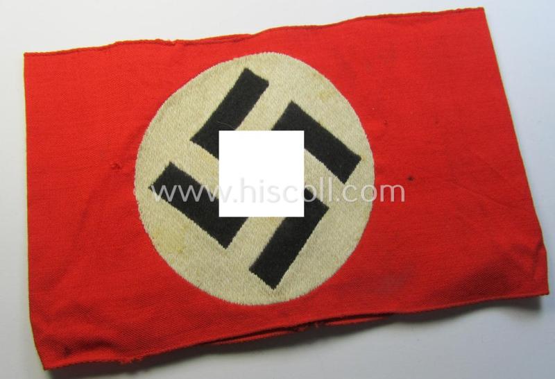 Superb - and just minimally used! - so-called: N.S.D.A.P.-related party-armband (ie. 'Armbinde') being of the 'entirely woven'-pattern showing an interwoven ie. 'machine-embroidered' swastika (ie. roundel)