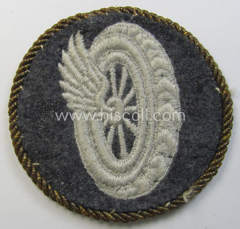 Attractive - albeit clearly used! - example of a WH (Luftwaffe) machine-embroidered, trade- ie. special-career-patch (ie. 'Tätigkeitsabzeichen') having a golden-coloured 'Goldkordel' attached as was intended for a: 'Schirrmeister o. Geräteverwalter'