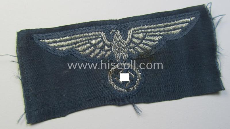 Superb, BZP (ie. 'Bahnschutz-Polizei') officers'-/ie. NCO-type side-cap- (ie. 'Schiffchen'-) eagle as woven in 'flat-wire-BeVo'-style and executed in bright-silver thread on a greyish-blue-coloured and linnen-based background