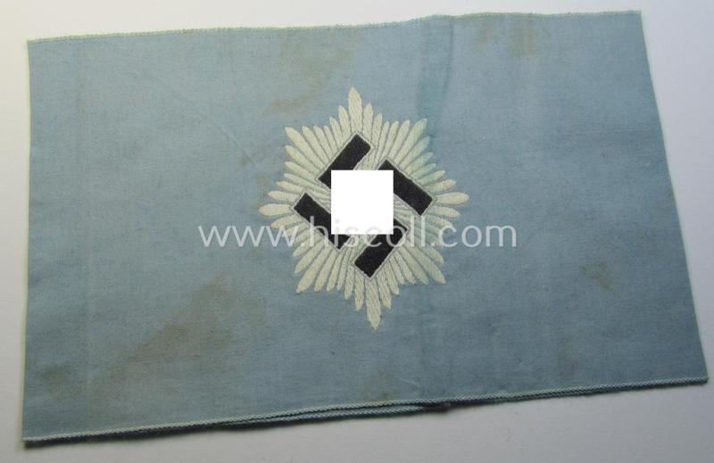Attractive, light-blue-coloured so-called: RLB (or: 'Reichsluftschutzbund') 'Amtsträger'-armband depicting the typical 'RLB'-logo (without lettering) and showing an interwoven makers'- ie. 'Ges.Gesch.'-designation