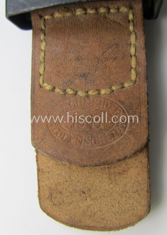 WH (Luftwaffe) bluish-grey-coloured, steel-based belt-buckle, being a maker- (ie. 'E. Schneider'-) marked- and/or: '1941'-dated example that comes mounted onto its leather-based tab and that comes in a 'virtually mint- ie. unissued'-, condition