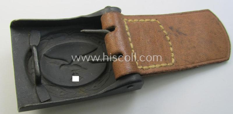 WH (Luftwaffe) bluish-grey-coloured, steel-based belt-buckle, being a maker- (ie. 'E. Schneider'-) marked- and/or: '1941'-dated example that comes mounted onto its leather-based tab and that comes in a 'virtually mint- ie. unissued'-, condition