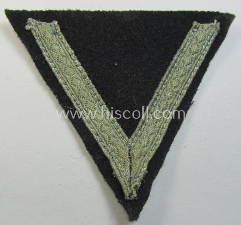 Attractive - and clearly used! - Waffen-SS- (ie. Heeres Panzer-) type 'Armwinkel' (or: rank-chevron) as executed on black-coloured wool as was intended for an: 'SS-Mann' (ie. 'Gefreiter')