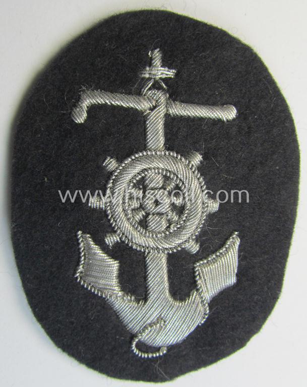 Superb, WH (Heeres) trade- and/or special-career insignia, being a detailed- and/or neatly hand-embroidered example as executed on darker-green-coloured wool, as was intended for a: 'Steuermann' (ie. enigineer-boat-pilot or helmsman)