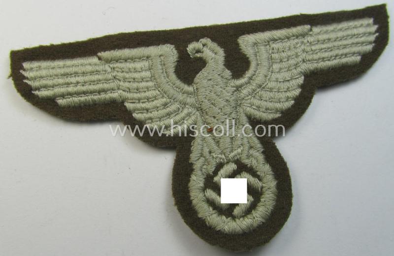 Attractive, machine-embroidered arm-eagle (ie. 'Ärmeladler') as was specifically intended for usage on the brownish-green-coloured tunics of officials of the: 'Reichsministerium für besetzte Ostgebiete' (ie. 'R.M.b.O.')