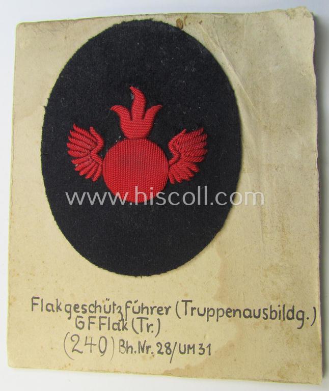 Unusual example of a neatly hand-embroidered WH (Kriegsmarine) trade- ie. special-career-patch (ie. 'Tätigkeitsabzeichen') as was intended for a: 'Flakgeschützführer (Truppenausbildg.)' (and that comes as period-attached on a carton 'card')