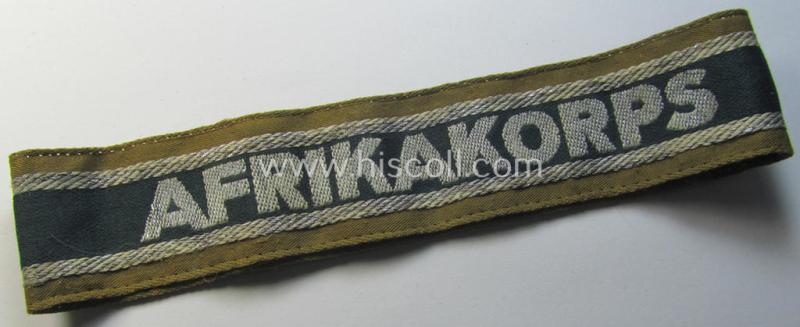 Superb, 'BeVo'-like cuff-title (ie. 'Ärmelstreifen') entitled: 'Afrikakorps' being a with certainty issued and truly worn example that comes in an overall nice- (ie. minimally shortened-, still sewn-together- and/or once tunic-attached-), condition