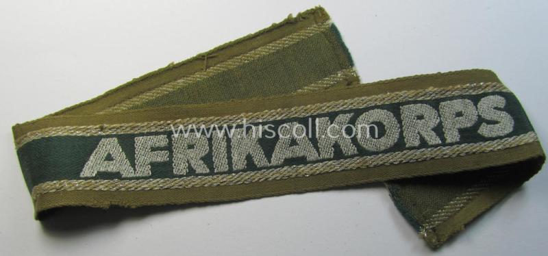 Attractive, 'BeVo'-like cuff-title (ie. 'Ärmelstreifen') entitled: 'Afrikakorps' being a with certainty issued and truly worn example that comes in an overall nice- (ie. minimally shortened-  and/or once tunic-attached-), condition