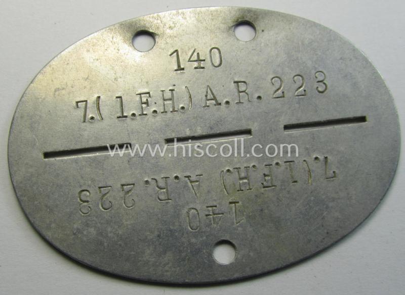 Aluminium-based, WH (Heeres) 'Artillerie'- (ie. artillery-) related ID-disc bearing the clearly stamped unit-designation that simply reads: '7.(l.F.H.) A.R. 223' and that comes as issued- and/or worn