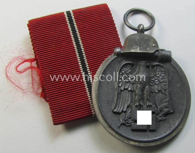 Attractive medal-set: 'Winterschlacht im Osten 1941-42' being a maker- (ie. '6.'-) marked- (and/or 'Feinzink'-based) specimen by the maker: 'Fritz Zimmermann' and that comes together with its (non-confectioned) ribbon (ie. 'Bandabschnitt')