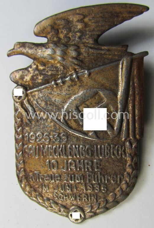Attractive, golden-bronze-toned N.S.D.A.P.-related day-badge (ie. 'tinnie') as was issued to commemorate a gathering entitled: '1925-35 - Gau Mecklenbg.-Lübeck - 10 Jahre im Treue zum Führer im Juni 1935 - Schwerin'