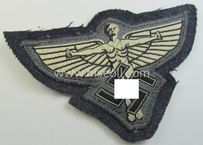 Attractive, bluish-grey-coloured, so-called: N.S.F.K.- (or: 'National Socialistisches Flieger Korps') breast-eagle being a nicely BeVo-woven- (and enlisted-mens'-pattern) example that comes mounted on its piece of bluish-coloured wool