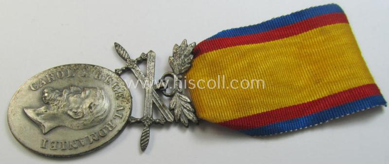 Attractive - and quite detailed! - example of a Romanian (WWII-period) medal: 'Medaille für Mannhaftigkeit und Treue in Silber' that comes mounted onto its original ribbon ie. 'Bandabschnitt' and that comes as issued- and worn