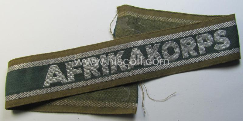 Attractive, 'BeVo'-like cuff-title (ie. 'Ärmelstreifen') entitled: 'Afrikakorps' being a with certainty issued and truly worn example that comes in an overall nice- (ie. minimally shortened- and/or once tunic-attached-), condition