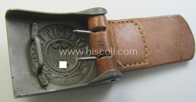 Attractive, WH (Heeres) field-grey-coloured- and/or steel-based belt-buckle being a maker- (ie. 'G.H. Osang'-) marked- and/or '1940' dated example that comes mounted onto its leather-based tab and that comes in a wonderful condition