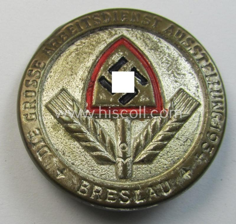 Attractive, silver-toned- (and/or tin-based) RAD- (ie. 'Reichsarbeitsdienst'-) related day-badge depicting the typical: 'RAD-Spaten' and text that simply reads: 'Die Grosse Arbeitsdienst Ausstellung - 1934 - Breslau'