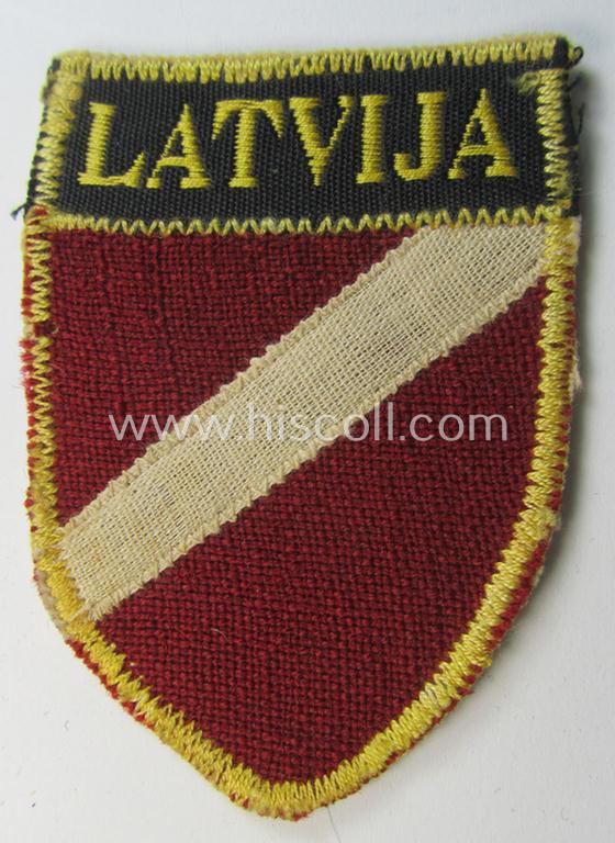 Superb - and truly rarely seen! - multi-piece-constructed, linnen-based and locally produced(!), 'Waffen-SS'-type armshield entitled: 'Latvia' as was merely intended for usage by the members of the: 'Latvian Legion'