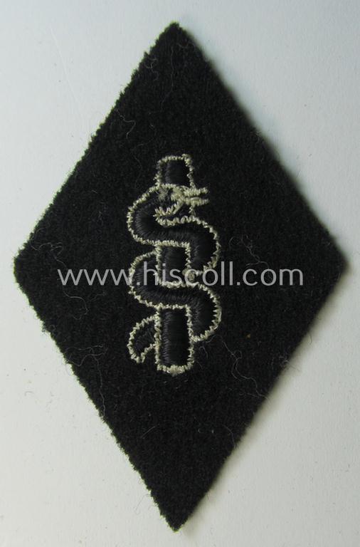 Waffen-SS-pattern, machine-embroidered and/or black- and white-coloured sleeve-insignia (ie. 'Ärmelraute') depicting a so-called: 'HJ-Raute' as was used and intended to signify membership within the 'SS-Sanitätsdienst'