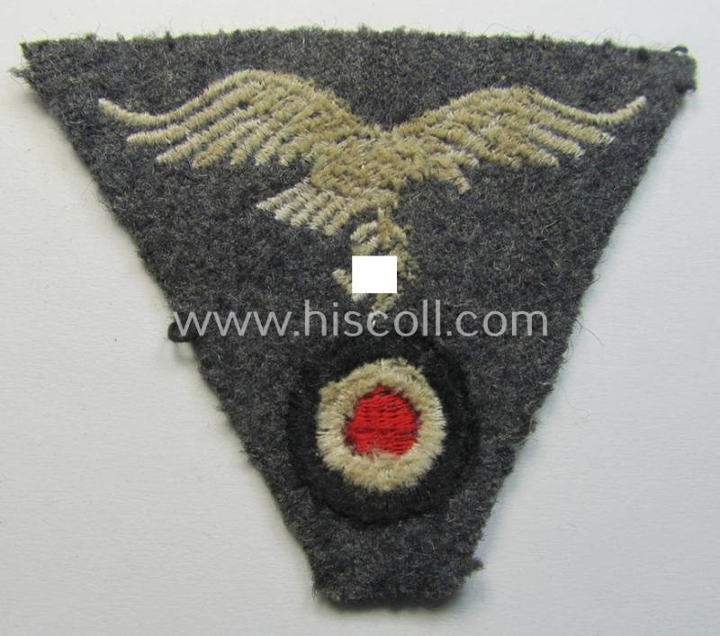 Attractive - and scarcely encountered! - WH (Luftwaffe) so-called: 'M43-pattern'-cap-trapezoid (being a machine-embroidered and carefully cap-removed example that is executed on a bluish-grey-coloured- and/or woolen-based background)