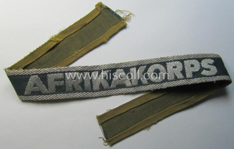 Attractive, 'BeVo'-like cuff-title (ie. 'Ärmelstreifen') entitled: 'Afrikakorps' being a with certainty issued and truly worn example that comes in an overall nice- (ie. minimally shortened- and/or once tunic-attached-), condition