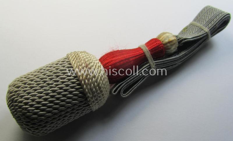 Attractive, white-, red- and red-coloured EM- (ie. NCO-) type side-arm knot (ie. 'Portepee' ie.: 'Troddel') as was used for the various WH-bayonets and that comes in an overall very nice- (ie. 'virtually mint- ie. unissued'-), condition