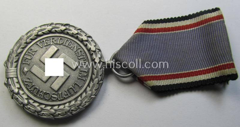 Neat, 'Luftschutz-Ehrenzeichen 2. Stufe' being a non-maker-marked example as executed in (light-weight) aluminium-based metal and that comes mounted onto its period (confectioned) ribbon ie. 'Bandabschnitt'