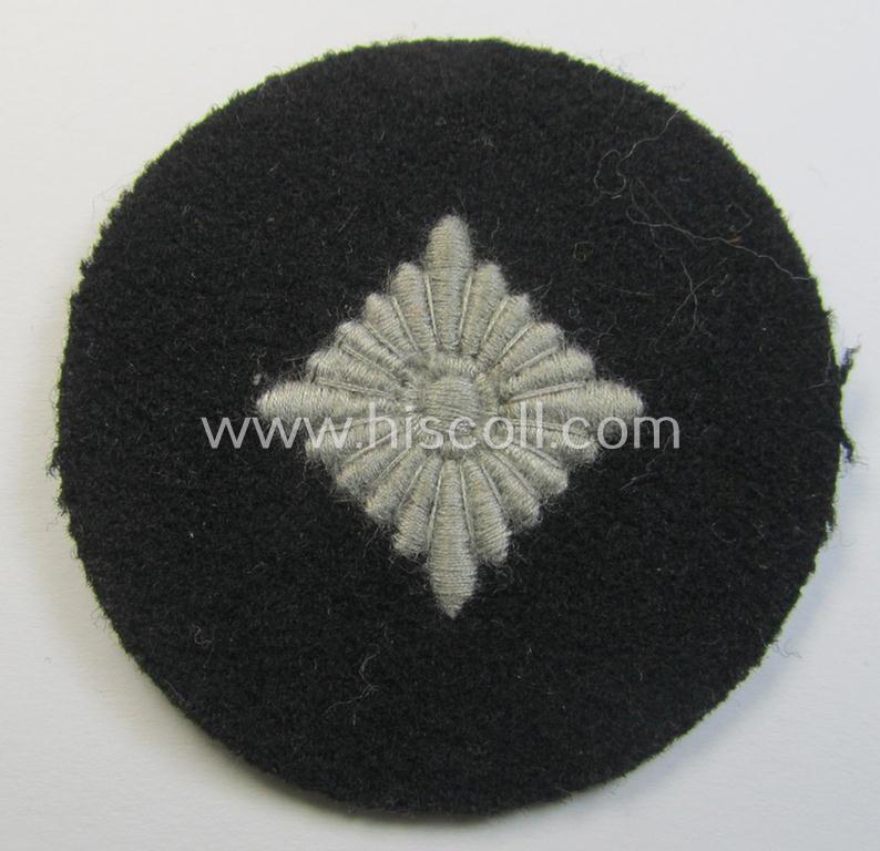 Waffen-SS- (ie. Heeres-'Panzer'-) type, machine-embroidered rank-badge (or: roundel) as was executed on smooth-type- and black-coloured wool as was intended for an: 'SS-Oberschütze' (ie. Heeres 'Oberschütze')