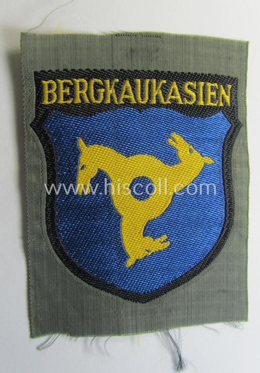 Attractive, 'BeVo'-type armshield (of the second pattern-) entitled: 'Bergkaukasien', being a piece as intended for a volunteer who served within the 'Deutsche Wehrmacht' ie. within the 'Berg- o. Nord-Kaukasisches Legion'