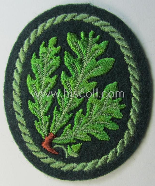 Attractive example of a WH (Heeres) so-called: 'Jäger'-armbadge being a neatly machine-embroidered- and/or multi-coloured version as was executed on darker-green-coloured wool