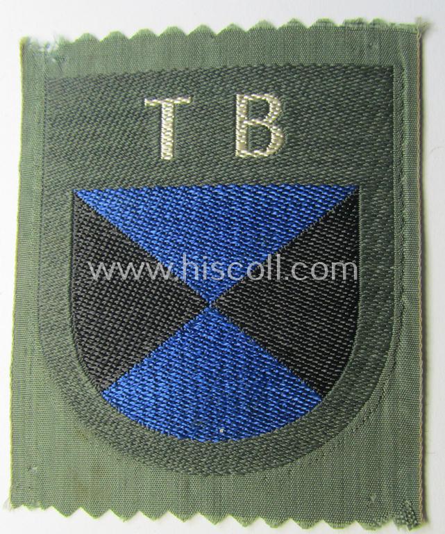 Attractive - and rarely seen! - armshield as executed in the neat 'BeVo'-weave pattern depicting the interwoven 'Cyrillic' characters: 'TB' (as was intended for the Russian volunteers serving within the 'Terek Cossacks')