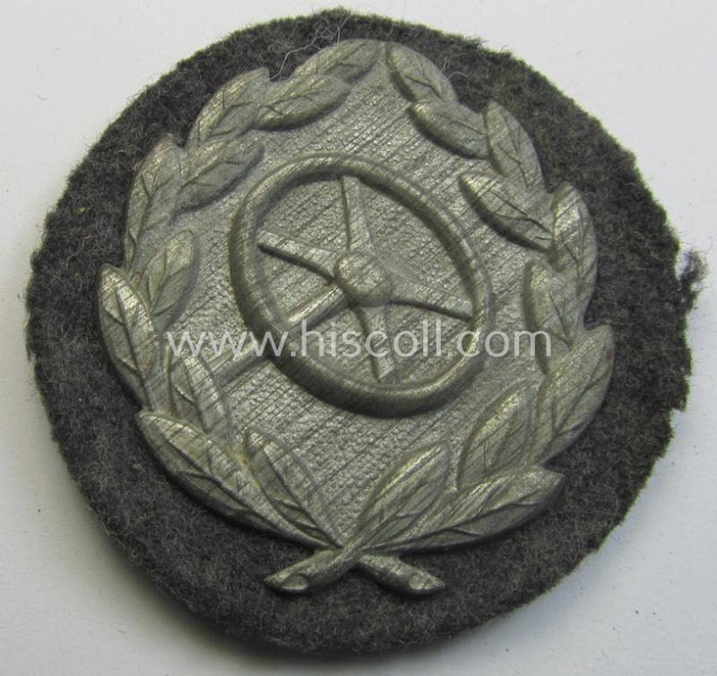 WH (Luftwaffe) so-called: 'Kraftfahrbewährungs-Abzeichen in Silber' (or: silver-class drivers' proficiency-badge) that comes mounted onto its piece of field-grey-coloured wool and that comes as probably issued- but hardly worn, condition