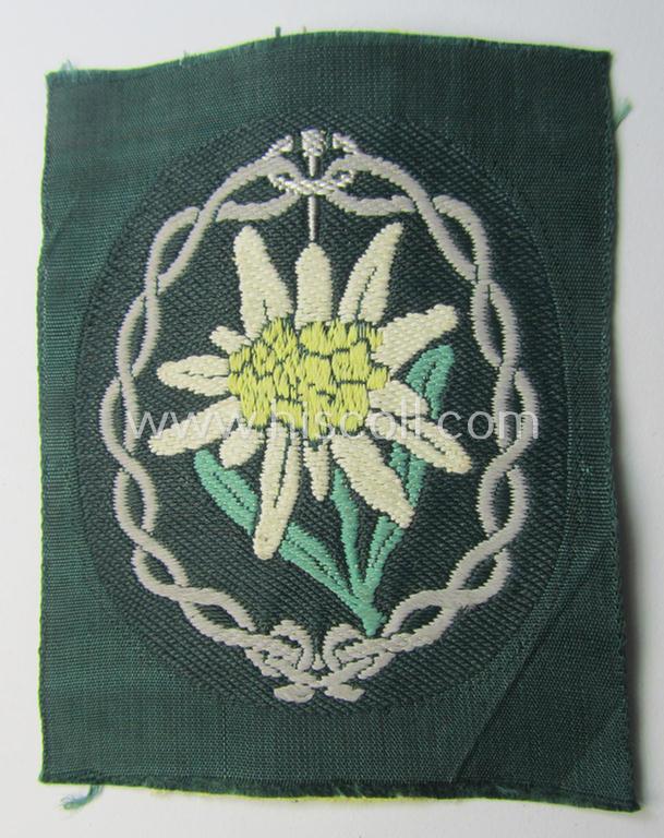 WH (Heeres) enlisted-mens'- (ie. NCO-) type, so-called: 'Edelweiss'-armpatch being a 'BeVo'-woven example as was executed on darker-green linnen as was specifically intended for usage by the: 'Gebirgsjäger-Truppen'