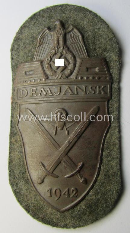 Superb example of a - fairly scarcely encountered! - WH (Heeres ie. Waffen-SS) 'Demjansk'-campaign-shield as executed in typical magnetic, so-called: 'Eisenblech' (and being of the 'missing-log' variant-pattern)