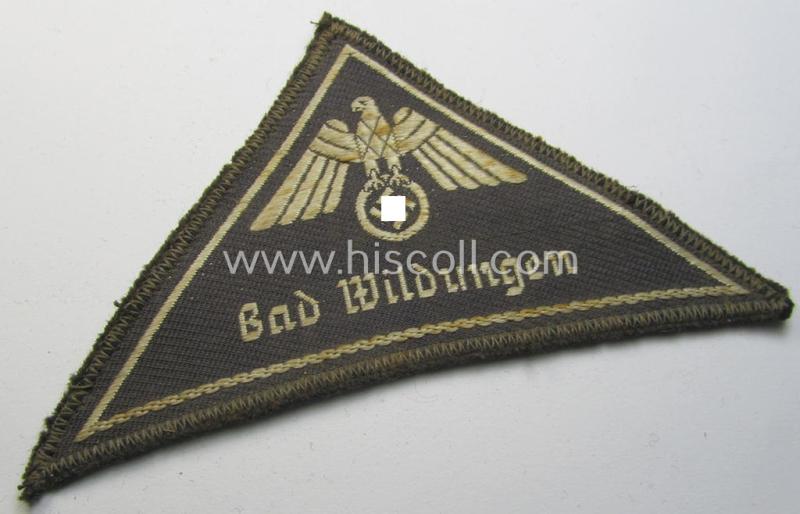 Attractive, German Red Cross (ie. 'Deutsches Rotes Kreuz' or 'DRK') related, EM- (ie. NCO-) type, greyish-coloured- and/or (typically) triangular-shaped arm-eagle as executed in the neat 'BeVo'-weave pattern entitled: 'Bad Wildungen'