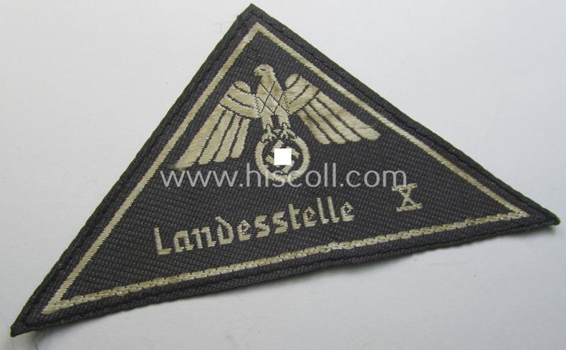 Attractive, German Red Cross (ie. 'Deutsches Rotes Kreuz' or 'DRK') related, EM- (ie. NCO-) type, greyish-coloured- and/or (typically) triangular-shaped arm-eagle as executed in the neat 'BeVo'-weave pattern entitled: 'Landesstelle X'