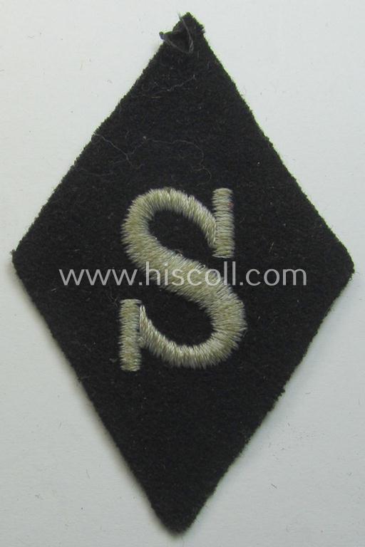 Attractive - and rarely found! - Waffen-SS-pattern, machine-embroidered and black-coloured sleeve-insignia (ie. 'Ärmelraute') depicting a captital: 'S'-character as was used to signify the function of: 'Schirrmeister' within the: 'Waffen-SS'