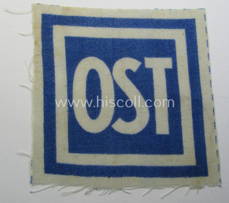 Neat, printed-version of a so-called: 'Ost'- (ie. forced-labour) breast-patch (ie. 'Brustabzeichen für Zwangsarbeiter o. Fremdarbeiter') being a non-confectioned example that comes in a never used- (ie 'virtually mint'-), condition