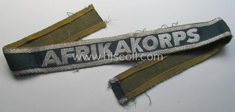 Attractive, 'BeVo'-like cuff-title (ie. 'Ärmelstreifen') entitled: 'Afrikakorps' being a with certainty issued and truly worn example that comes in an overall nice- (ie. hardly shortened- and/or once tunic-attached-), condition