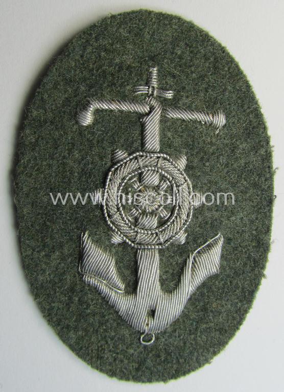 Superb, WH (Heeres) trade- and/or special-career insignia being a detailed- and/or neatly hand-embroidered example as executed on field-grey-coloured wool as was intended for a: 'Steuermann' (ie. enigineer-boat-pilot or helmsman)