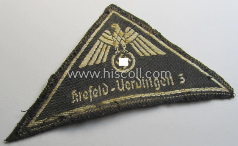 Attractive, German Red Cross (ie. 'Deutsches Rotes Kreuz' or 'DRK') related, EM- (ie. NCO-) type, greyish-coloured- and/or (typically) triangular-shaped arm-eagle as executed in the neat 'BeVo'-weave pattern entitled: 'Krefeld-Uerdingen 3'