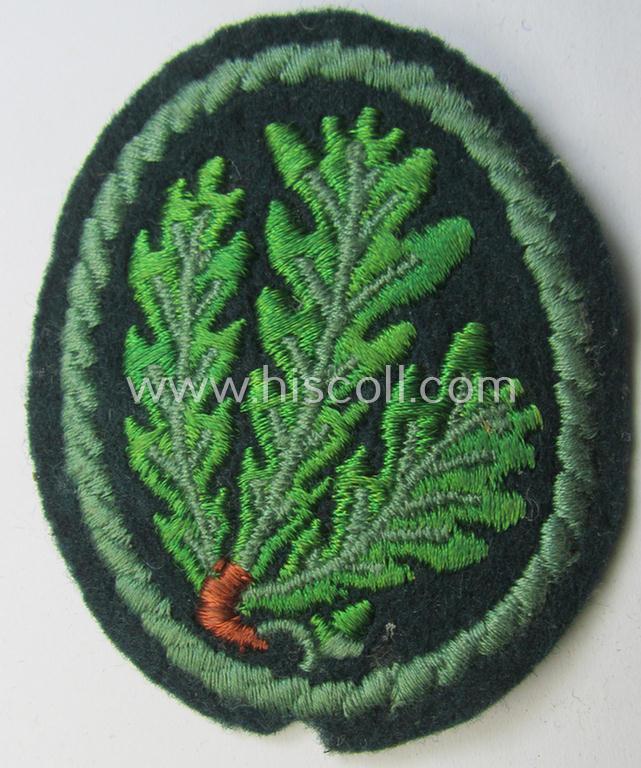 Attractive example of a WH (Heeres) so-called: 'Jäger'-armbadge being a neatly machine-embroidered- and/or multi-coloured version as was executed on darker-green-coloured wool