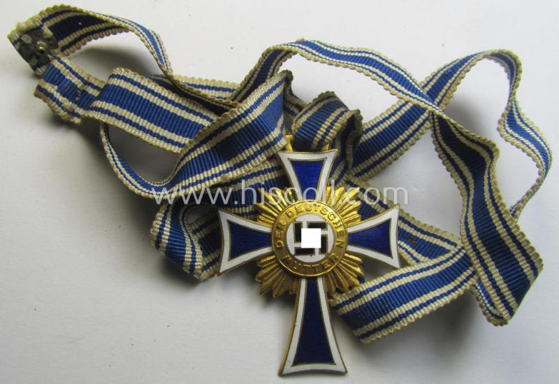 Attractive, 'Ehrenkreuz der deutschen Mutter - erste Stufe' (or: golden-class mothers'-cross) being a hardly used example that comes mounted onto its accompanying, long-sized ribbon as issued and/or recently found