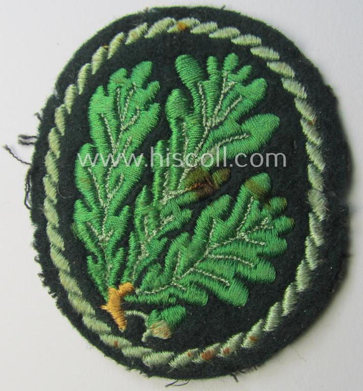 Attractive example of a WH (Heeres) so-called: 'Jäger'-armbadge being a neatly machine-embroidered- and/or multi-coloured version as was executed on darker-green-coloured wool